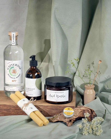 Vodka paired with hand cream, lip balm, Beeswax candles and bath salts for the Orchard Unwind Hamper