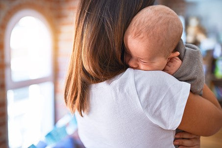 1. Mother holding baby over her shoulder