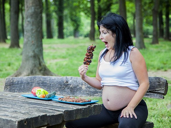 1. Pregnant woman eaiting a BBQ kebab