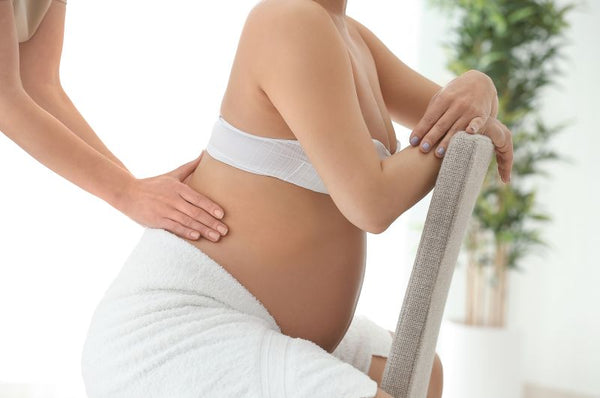 1. Pregnant woman having a lower back massage