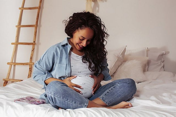1. Pregnant woman looking at her baby bump