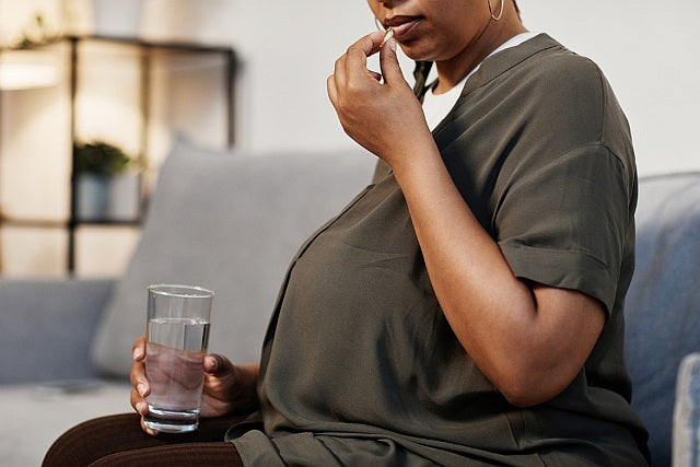 1. Pregnant woman taking supplements