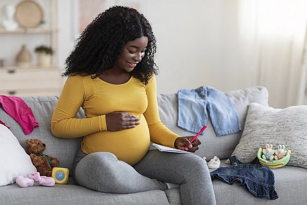 1. pregnant woman sat on her couch making a hospital checklist