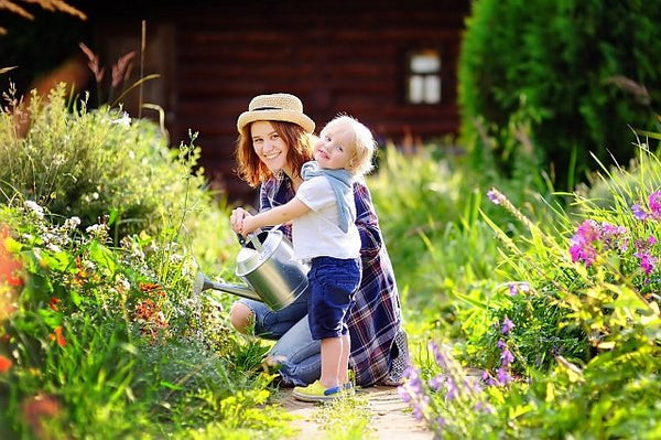 2. mum and child watering garden flowers