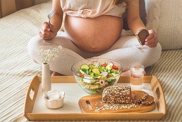 3. Pregnant woman eating slad with seeded bread