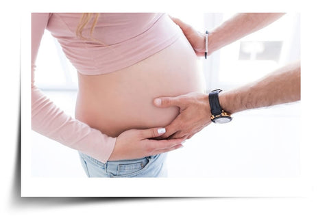 Hands Holding Bump - Stretch Mark Prevention