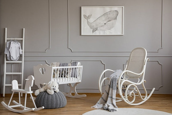 Nursery bedroom with white cot and rocking chair
