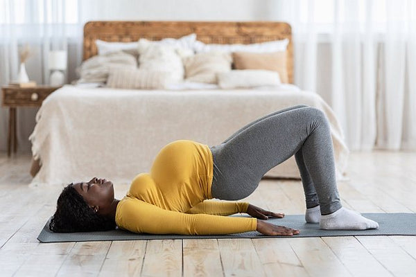 4. Pregnant woman on a yoga mat exercising