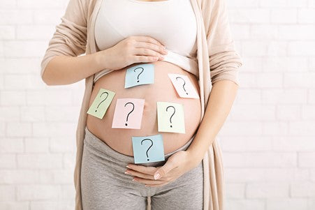 4. pregnant mum to be with question marks on post-it notes on her tummy