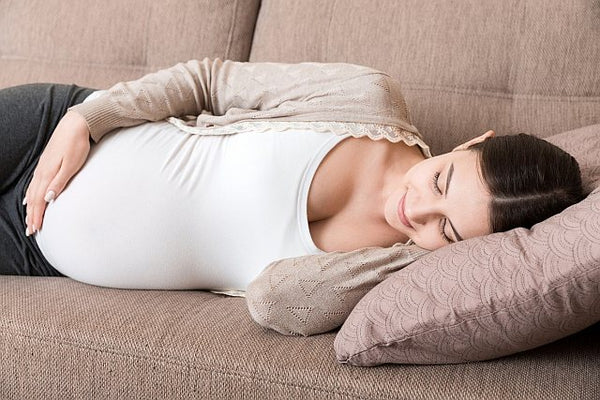 5. sleeping pregnant woman on a couch