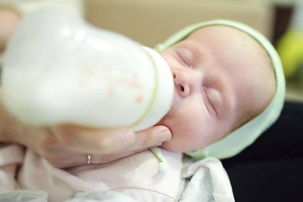 6. Baby feeding on formula bottle