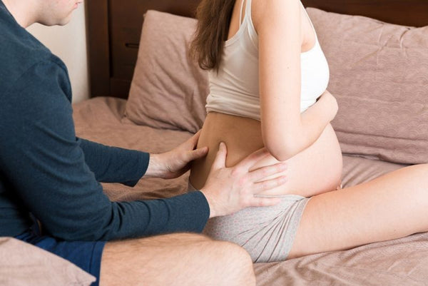 6. pregnant woman having back massage from partner