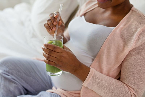 9. pregnant woman drinking green smoothie