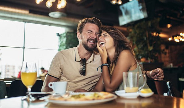 Couple laughing over diner
