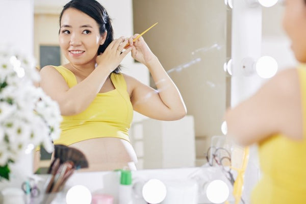 Pregnant lady brushing her hair