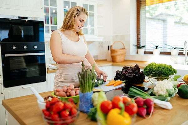 early pregnancy woman preparing healthy organic food