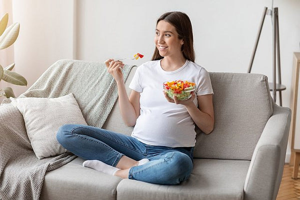 mum-to-be eating healthy food from a bowl