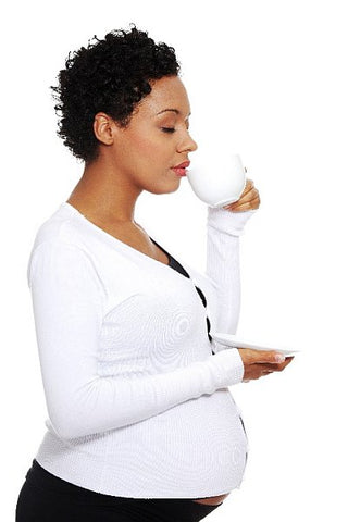 pregnant mum to be drinking coffee