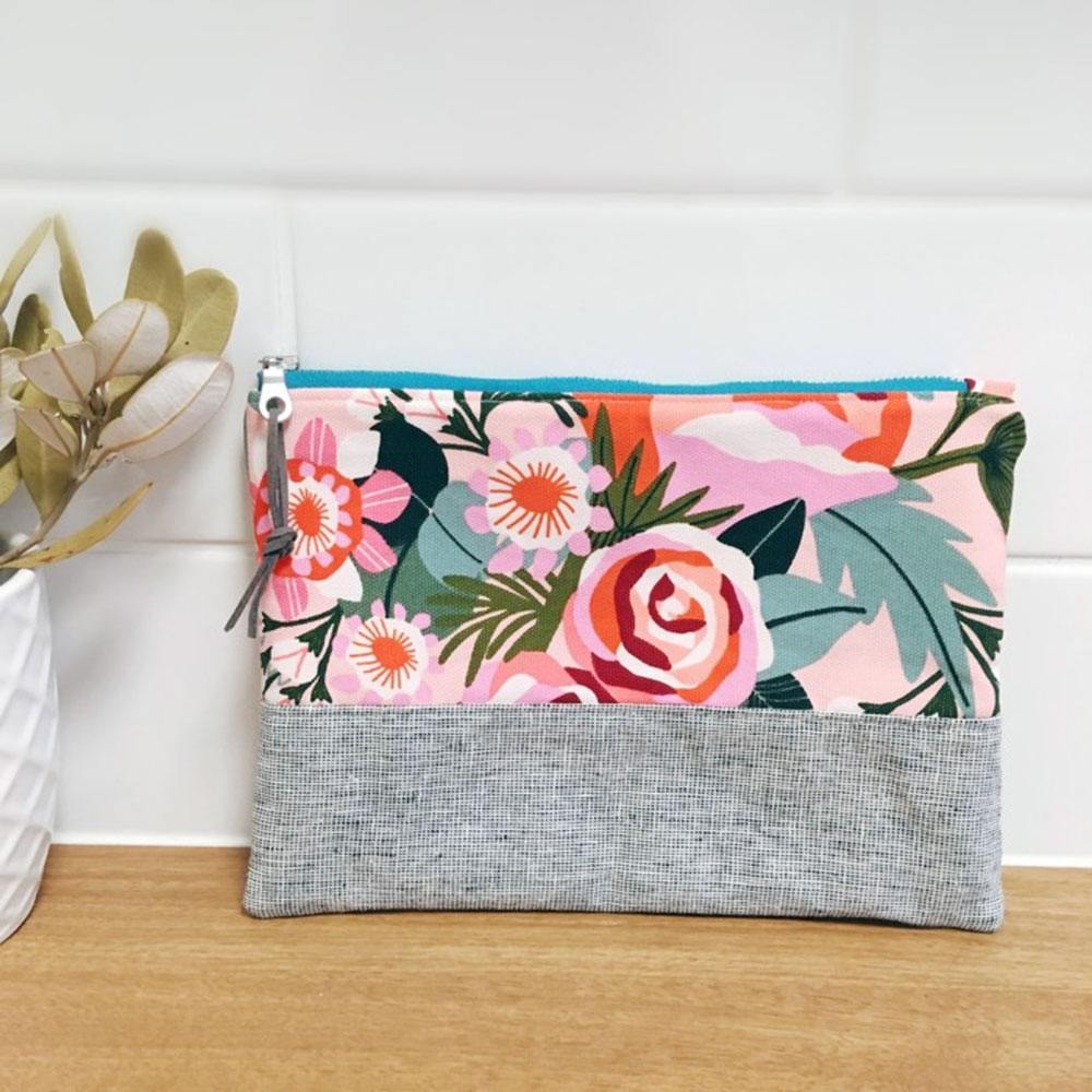 A Banksia and Bloom zippered pouch in grey and bold Kirsten Katz floral print panels