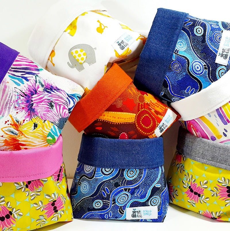 A stack of Birdy & the Boys fabric baskets in a range of bright and colourful prints