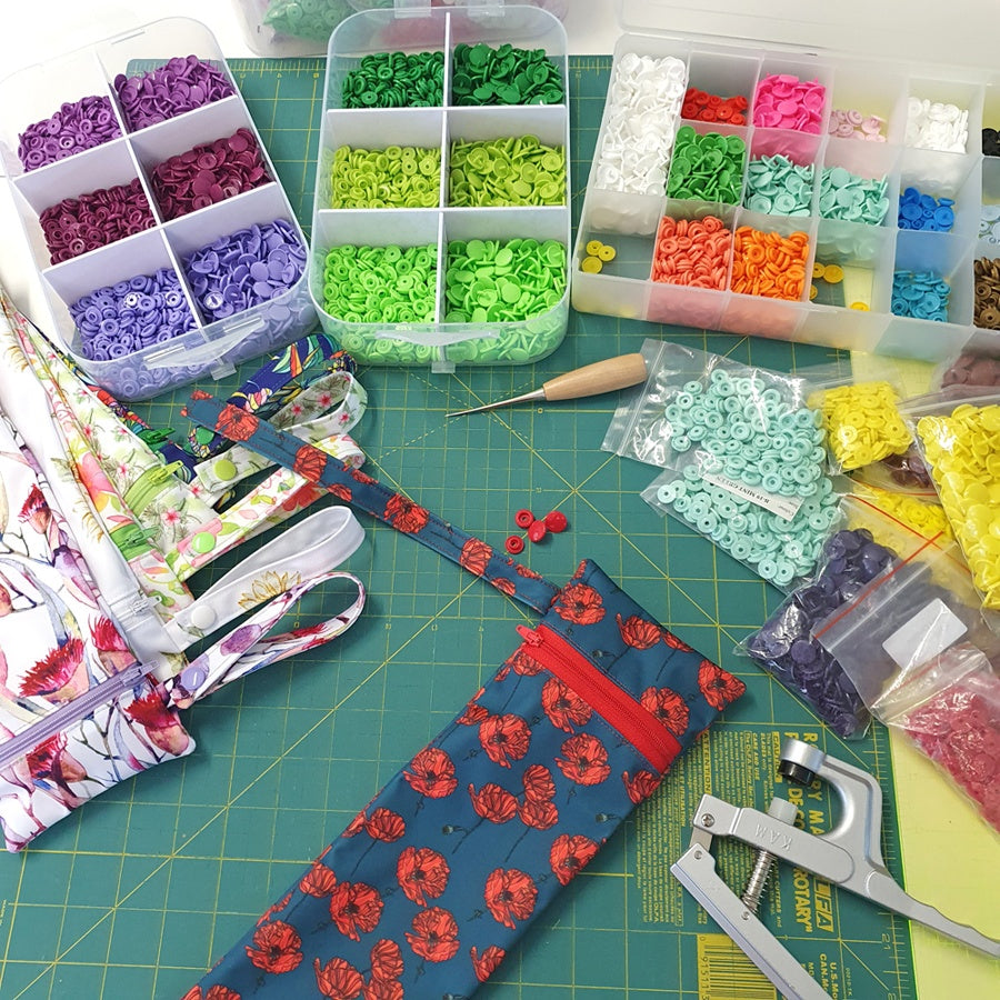 MarcelienaÕs work bench covered in colourful buttons and a range of umbrella covers in progress