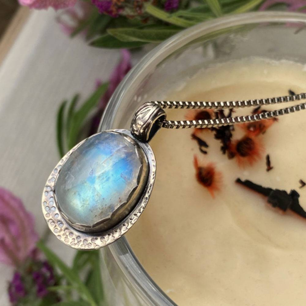 ÔFull MoonÕ: Stirling silver bezel pendant with a hammered finish set with rainbow moonstone