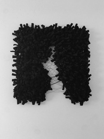 black wall sculpture made of wool. soft sculpture in fiber