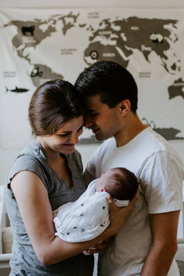 mum and dad as first-time parents and their newborn baby