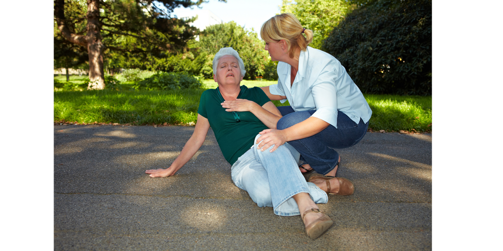 Woman helps senior citizen after falling