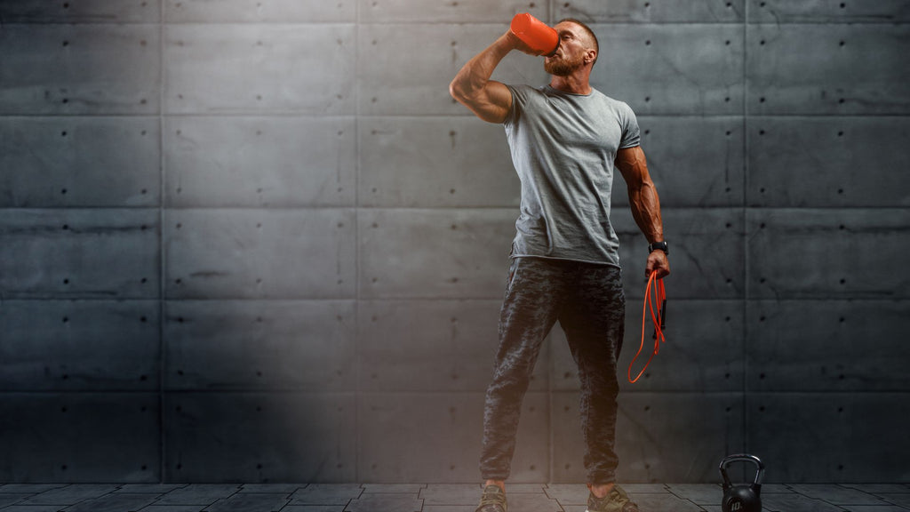 Man taking pre-workout supplements to enhance physical performance in the gym