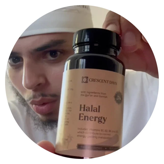 Person holding a bottle of Crescent Days Halal Energy supplements.