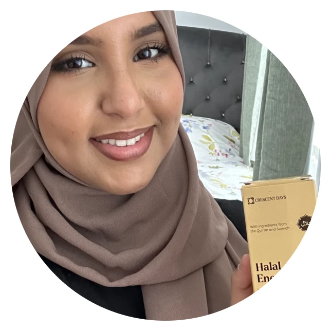 A person wearing a headscarf smiles and holds a box labeled 'Halal Energy.'