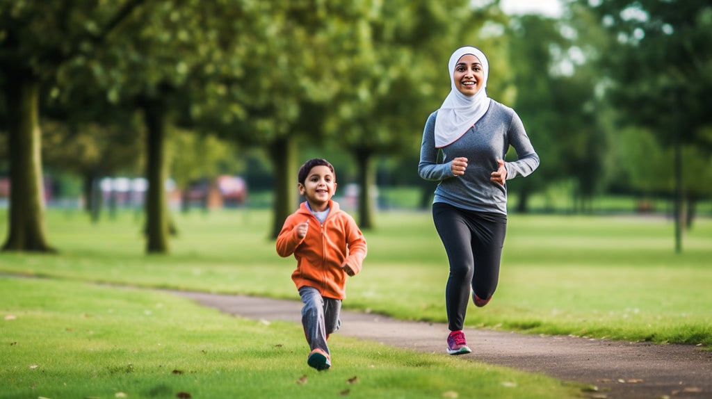 Muslim mother and her son enjoying a joyful run in the park, embodying active family lifestyle in Islam