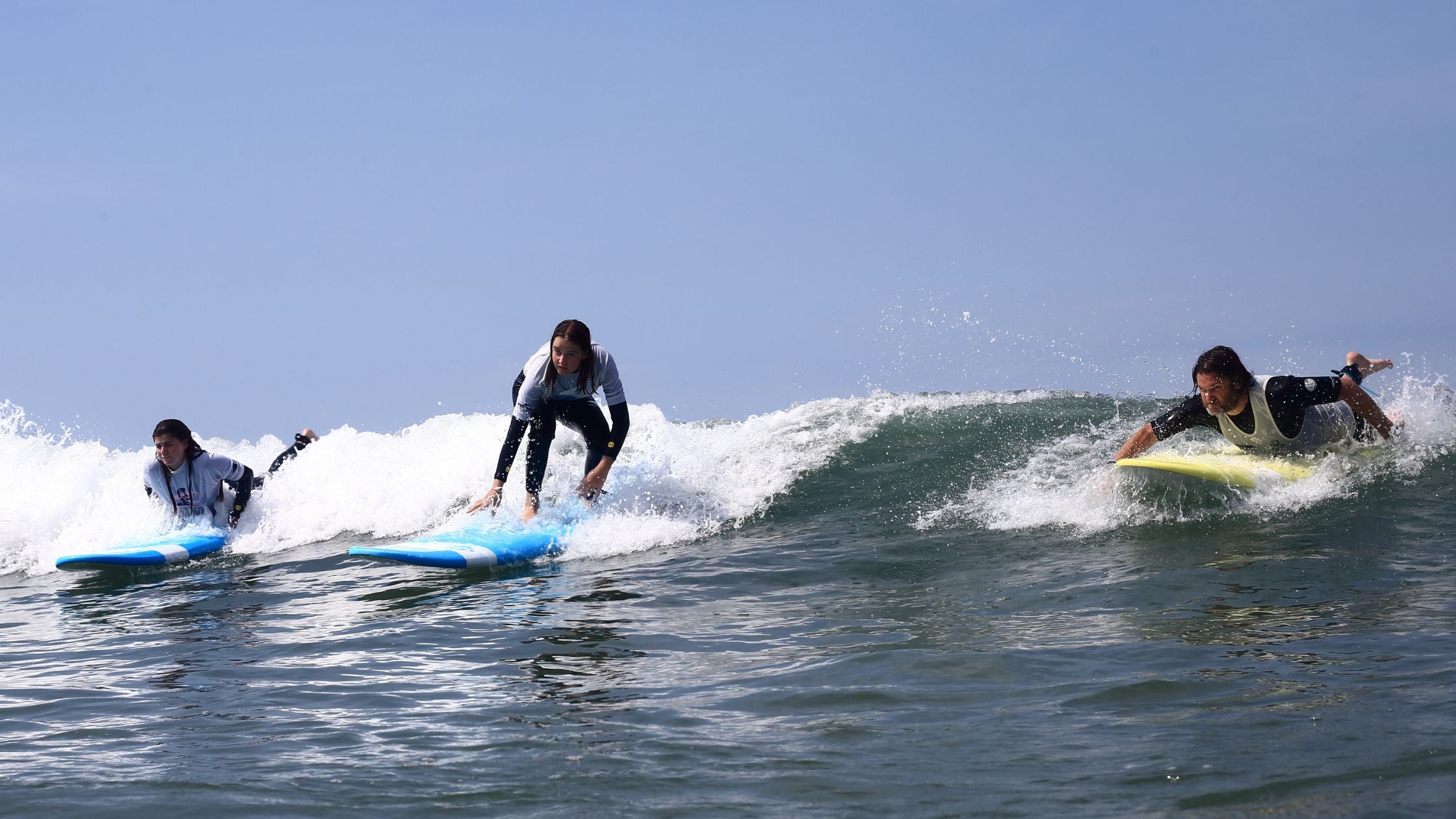 Beginners catching their first waves in surfing