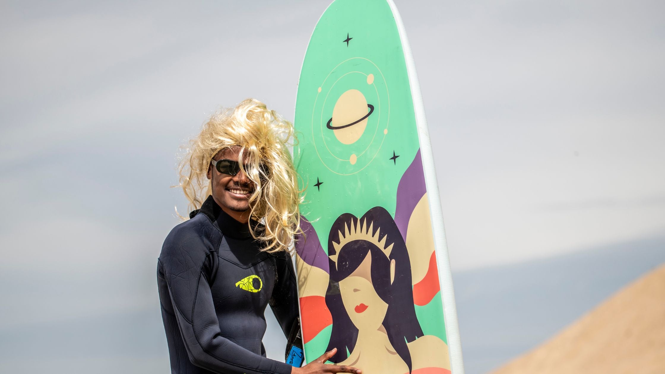 A happy surfer with a Zeus foam surfboard