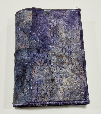 Dyed, painted and stitched wet wipes used to make a book cover