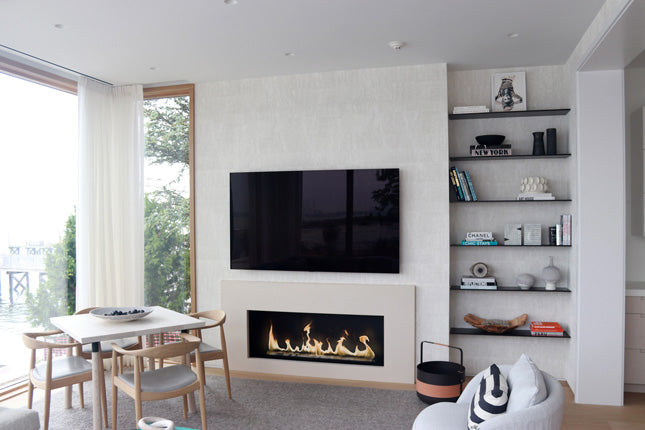 a fireplace burner embedded in a white wall under a tv