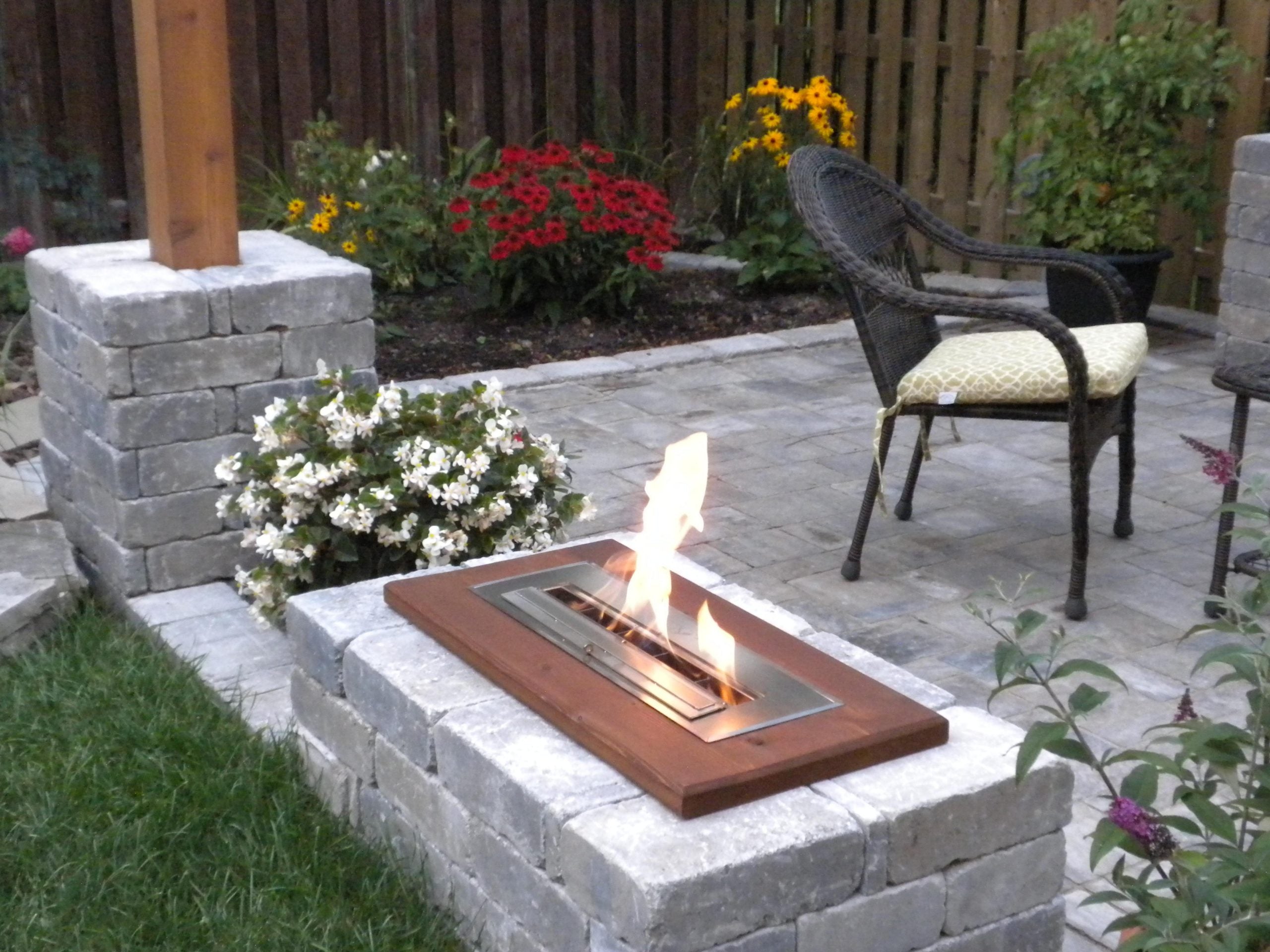 A fireplace burner on a patio.