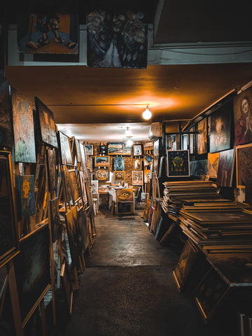 artist studio filled with paintings of all sizes