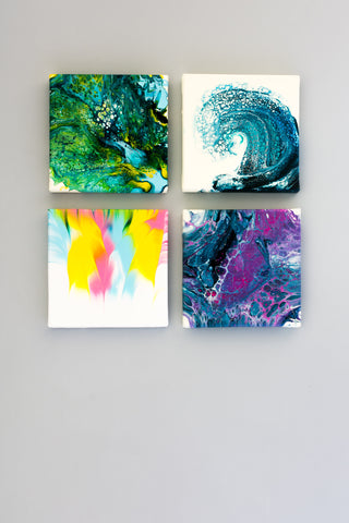 four different painting on canvas paired together hung on wall