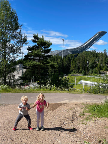 two kids in front of the holmenkollen ski jump