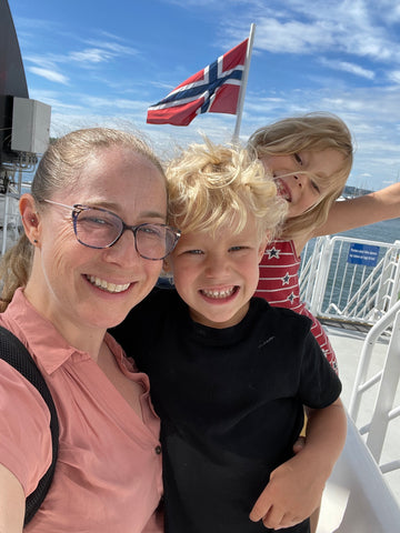 mom and kids on a boat in Norway
