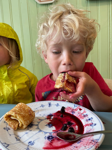 boy eating Norwegian pancake