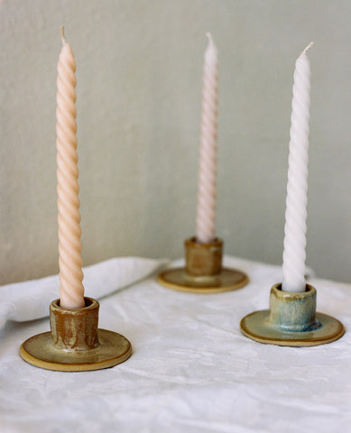 3 candles in handmade ceramic candle stick holders