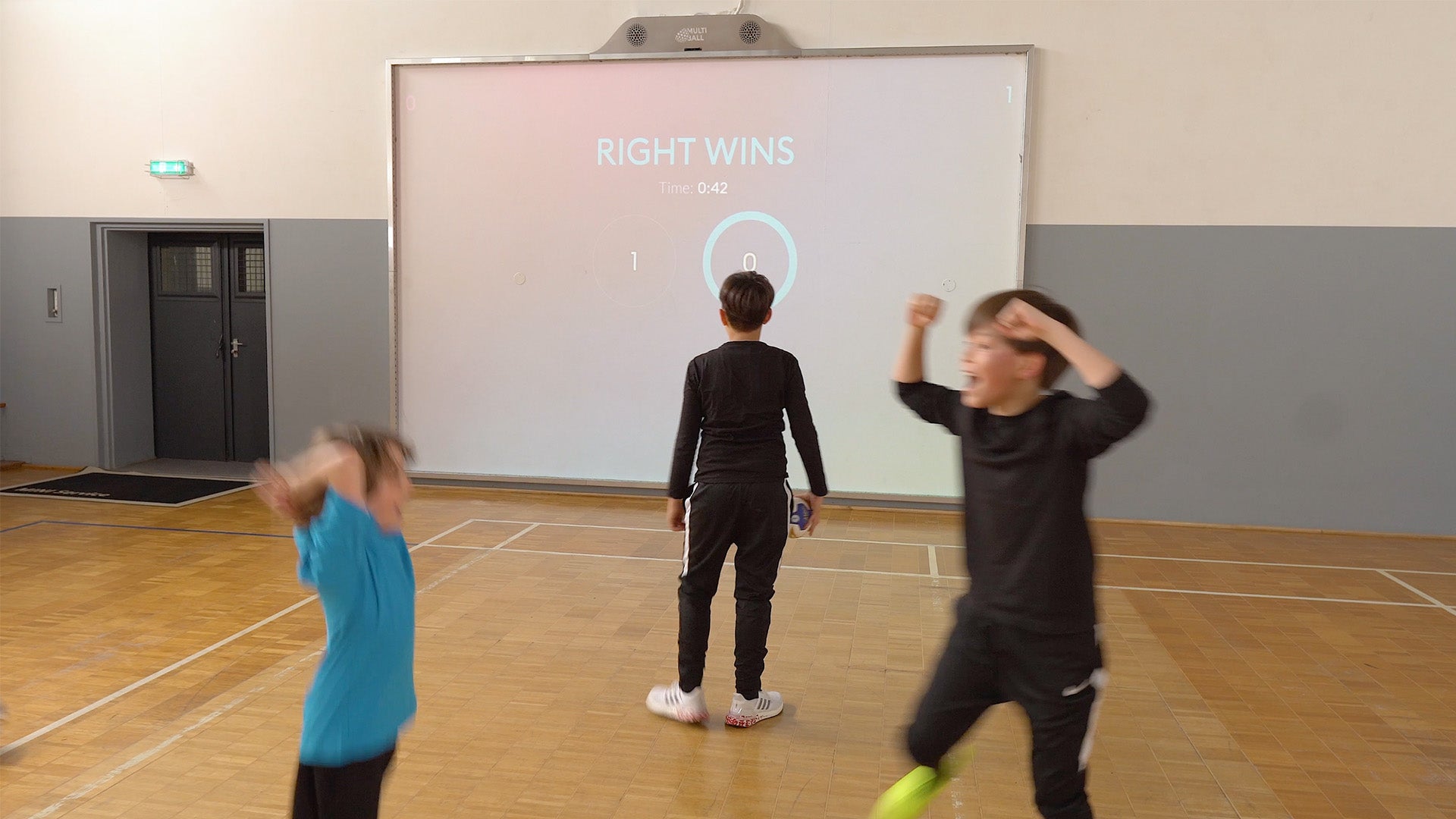 Two kids celebrate a win in a handball game on MultiBall