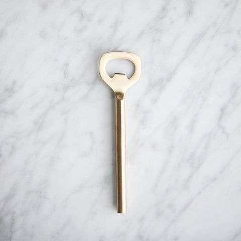https://cdn.shopify.com/s/files/1/0763/2411/products/simple-brass-bottle-opener_519c04a4-c6a2-4511-b7d7-2ce921856a8c_large.jpg?v=1647975272