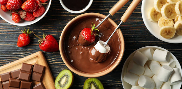 Strawberries and marshmallows being dipped in Pyure Hazelnut Spread. 