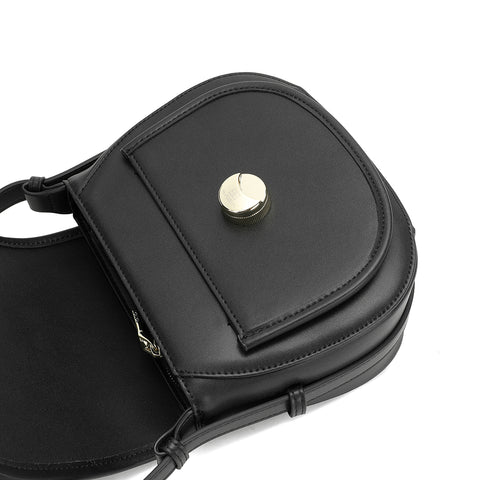 Adjustable strap and metal details on a black leather crossbody bag