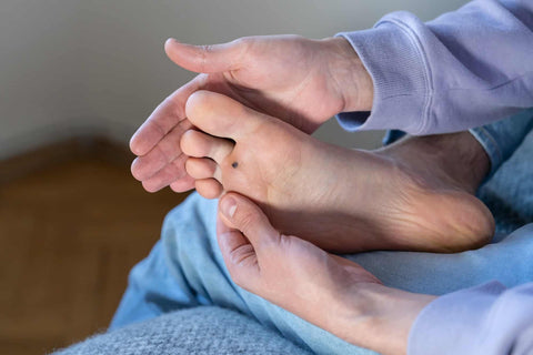 man-checks-callous-on-his-feet