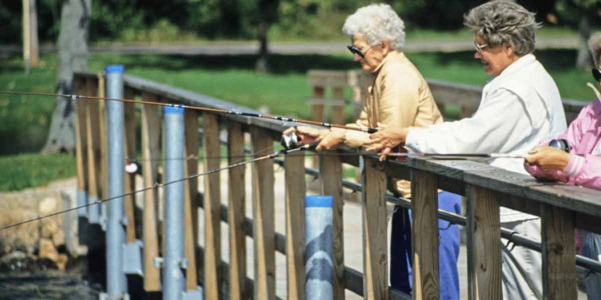 3 women fishing of boardwalk